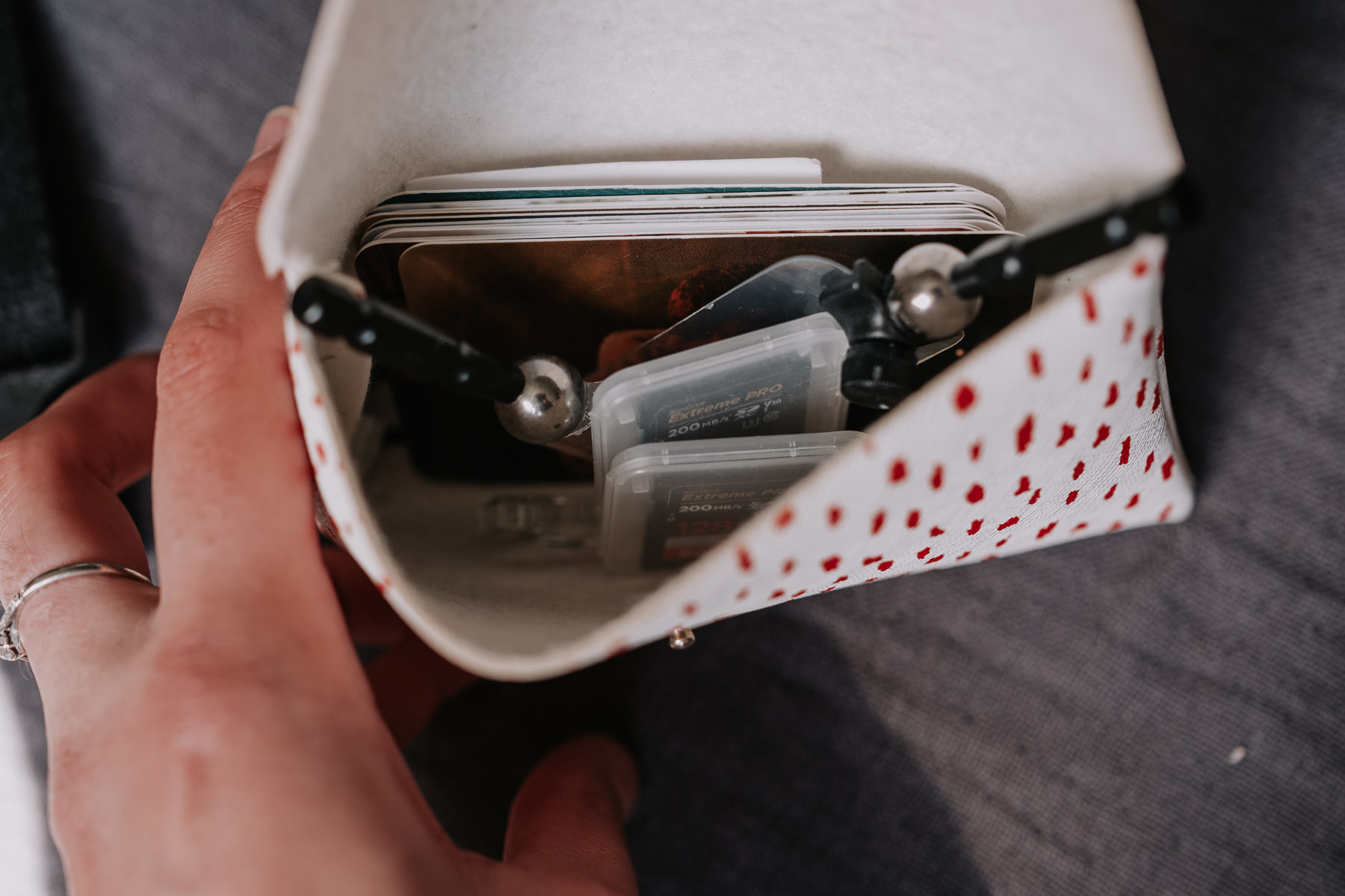 a hand holding a wallet with several cards inside