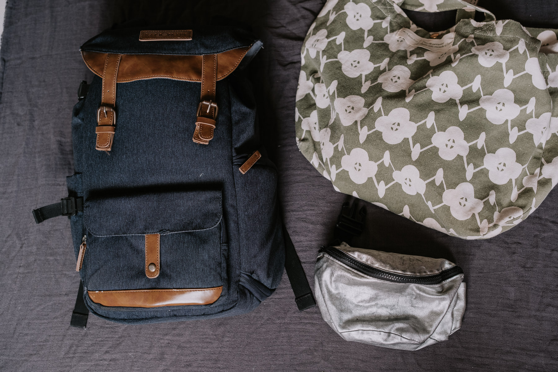 a backpack and a bag next to each other