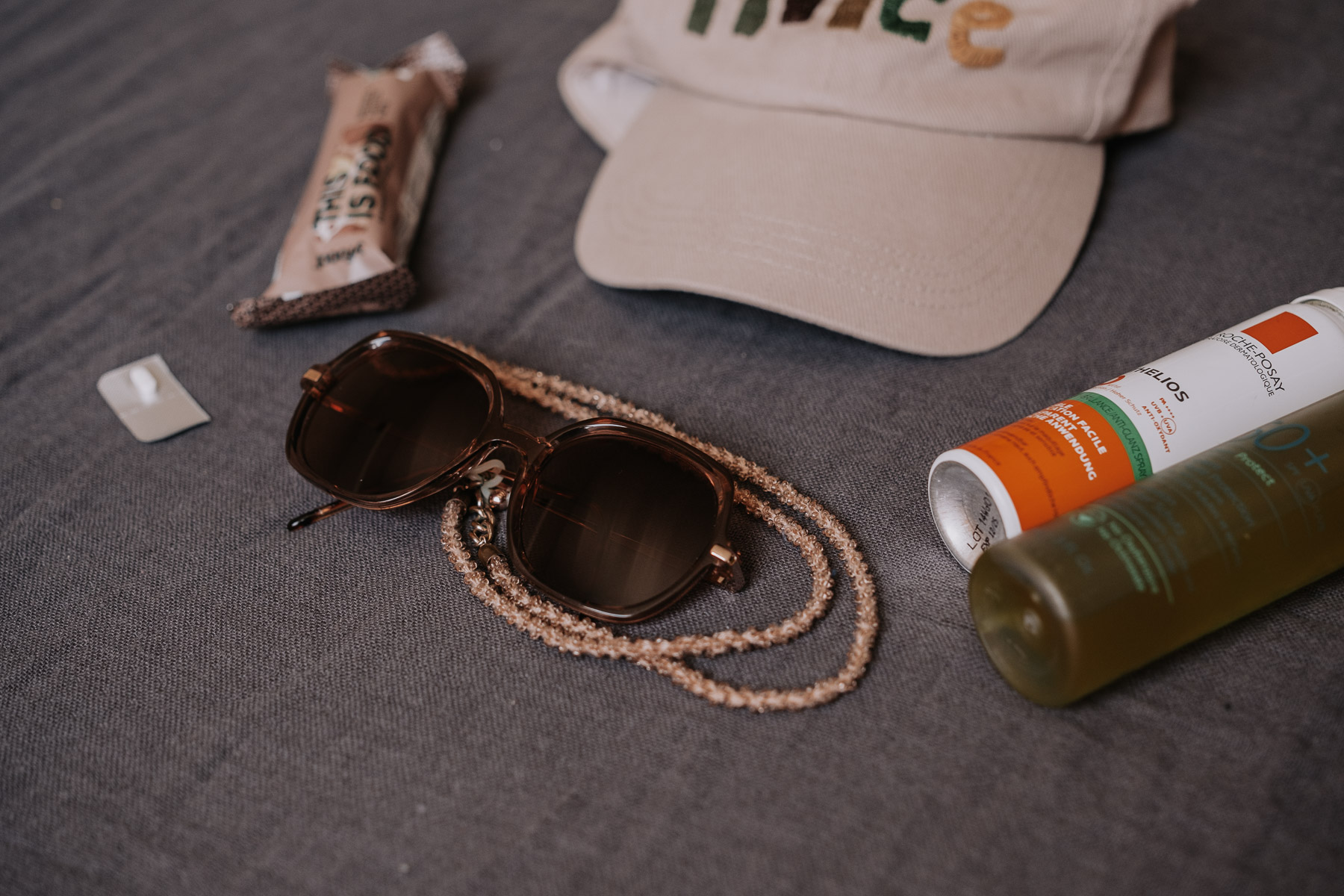 a sunglasses and a cap on a table