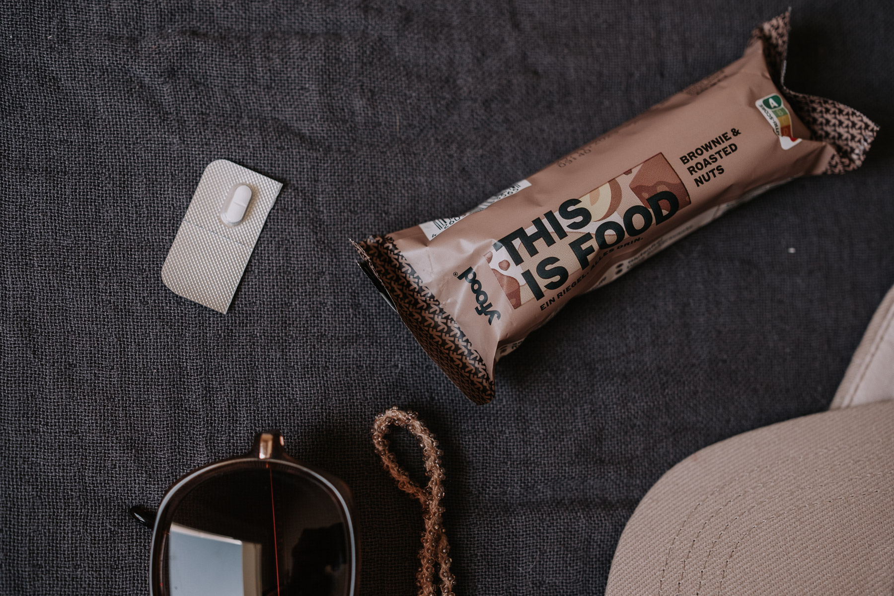 a bag of food next to a pill and sunglasses