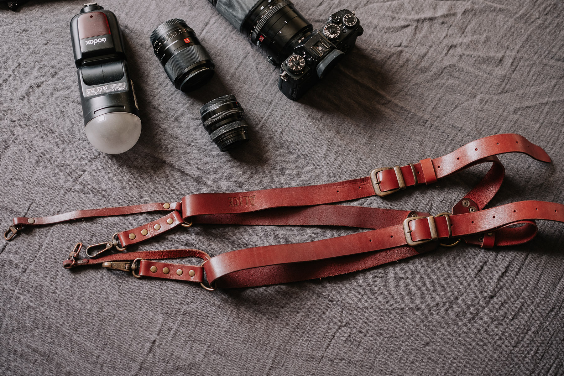 a camera and strap on a table