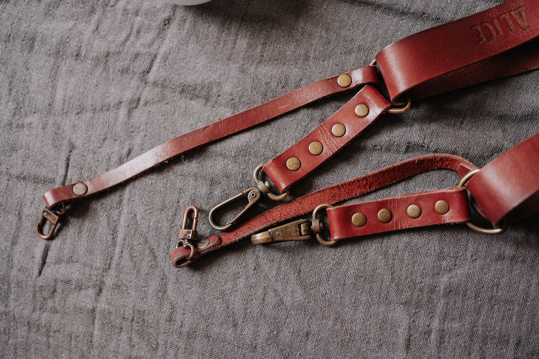 a red leather strap with a snap hook