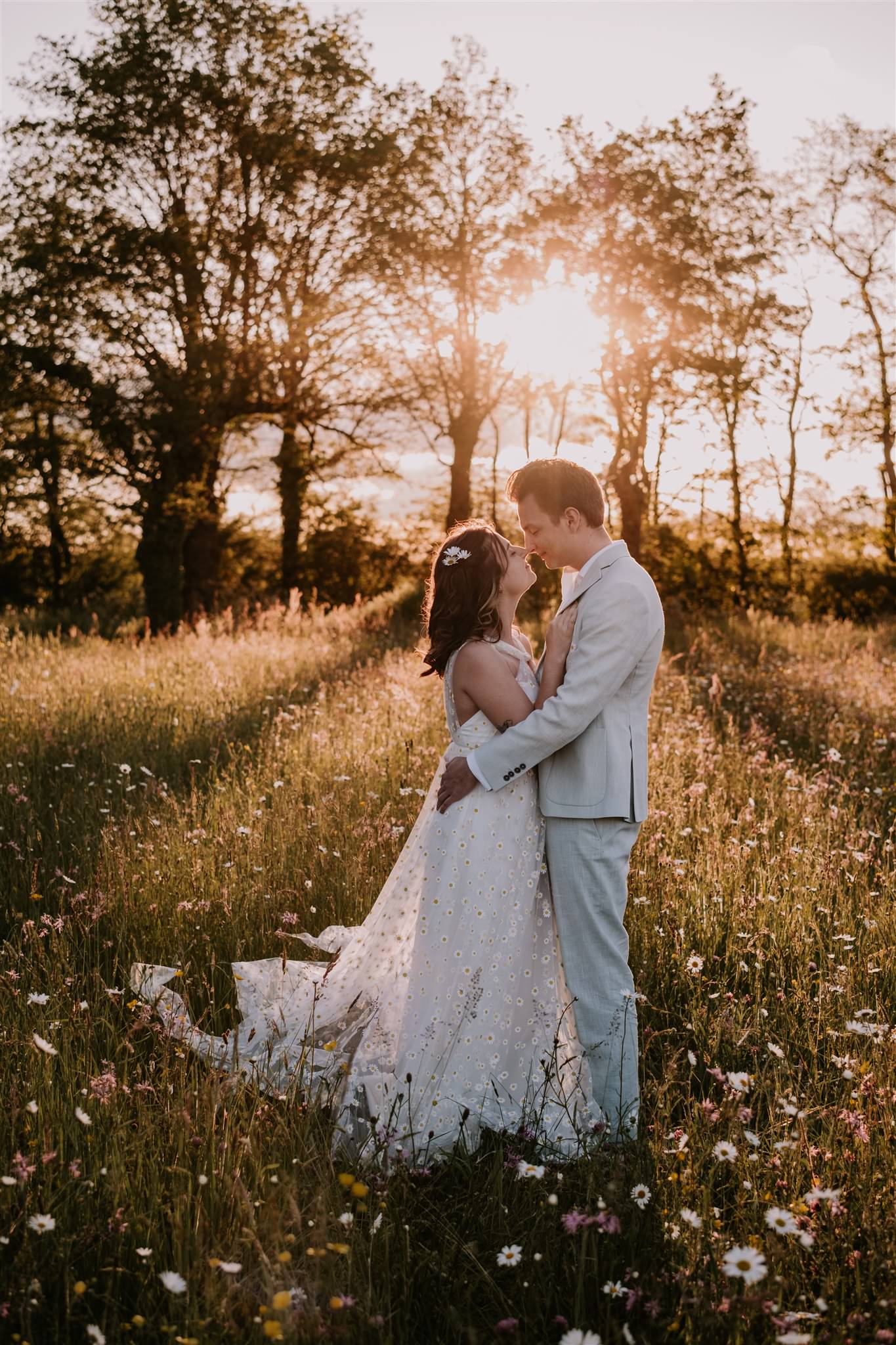 a man and woman in a field of flowers